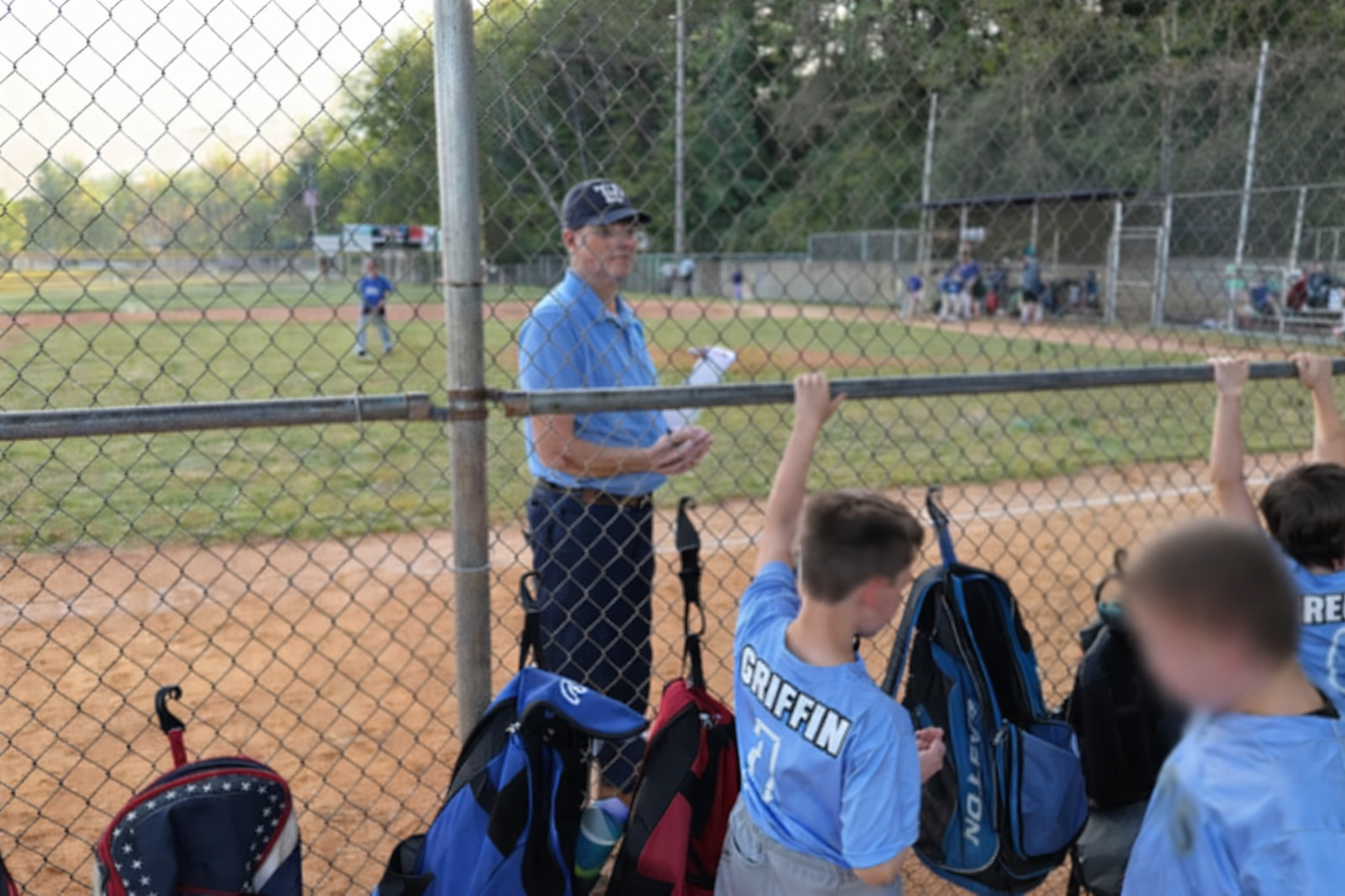 Greg coaching from the sideline at a baseball game