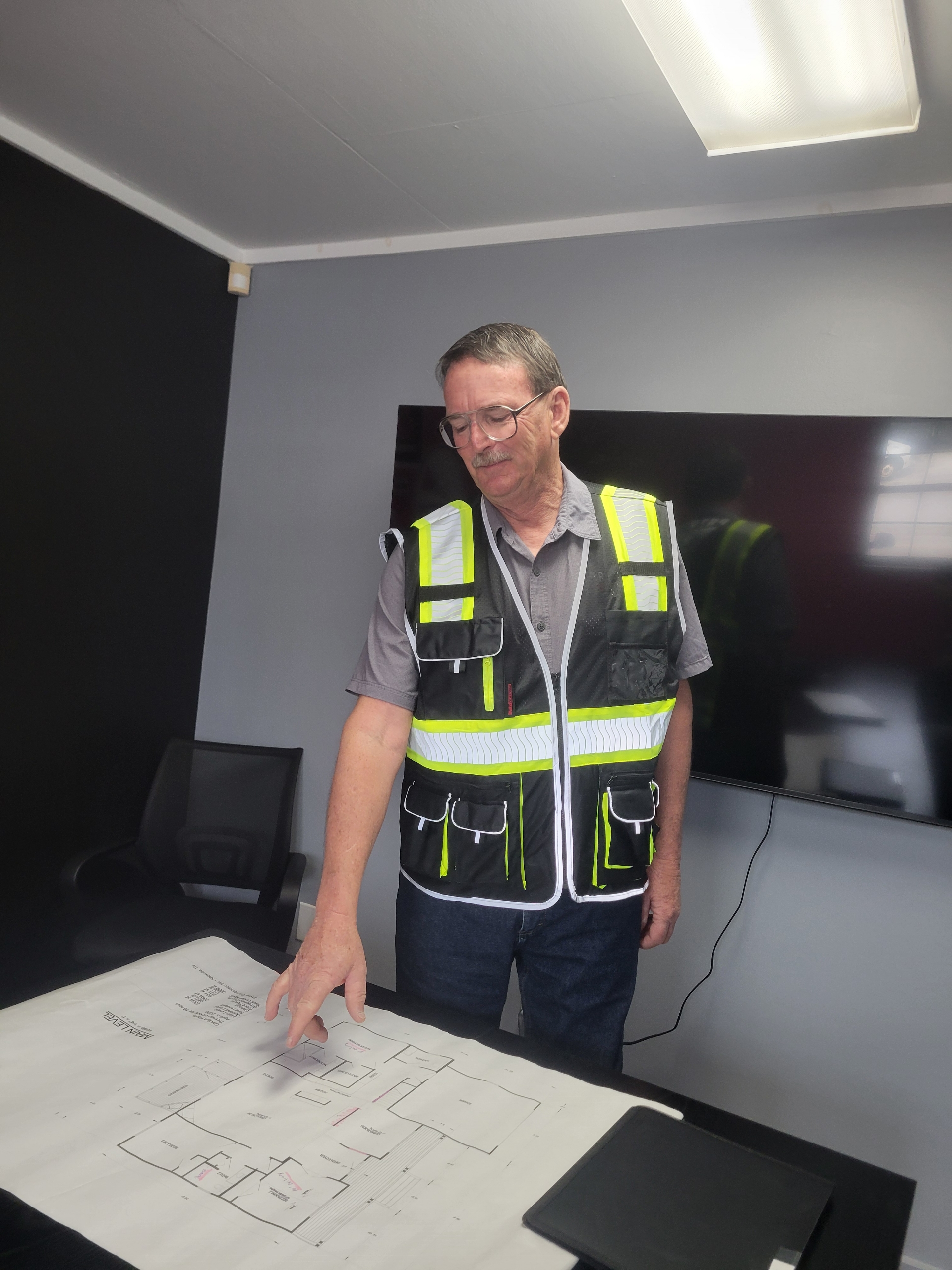 Greg reviewing building plans